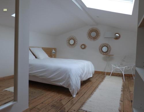 a bedroom with a bed and two mirrors on the wall at Maison En Ville in Niort