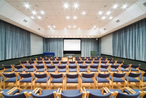 an empty lecture hall with chairs and a podium at Hotel IOR in Poznań