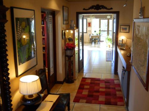 a hallway of a home with a table and a lamp at Les Rochers in Saint-Savin