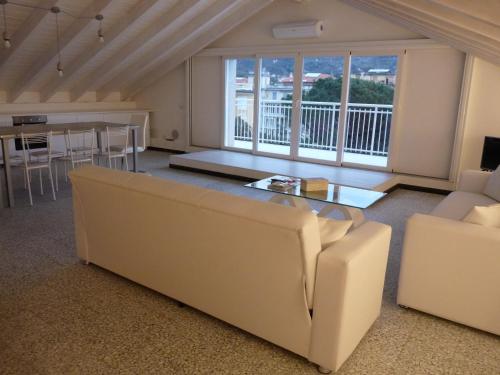 a living room with a couch and a table at Penthouse by the Sea in Levanto