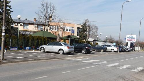 a row of cars parked in a parking lot at Hotel MK, Plavi restoran, Loznica in Loznica