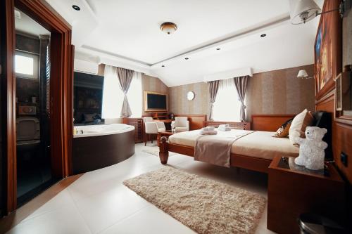 a hotel room with a bed and a bath tub at Lux apartmani Beograd in Belgrade