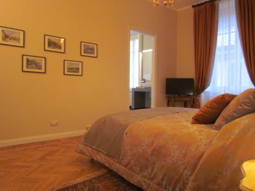 a bedroom with a bed and a television in it at L'Approdo di Sant'Agostino in Como