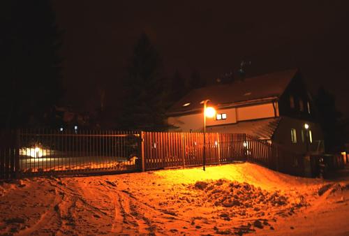 a fence in front of a house at night at Haus Tolštejn in Jiřetín pod Jedlovou
