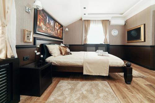 a bedroom with a large bed and a window at Lux apartmani Beograd in Belgrade