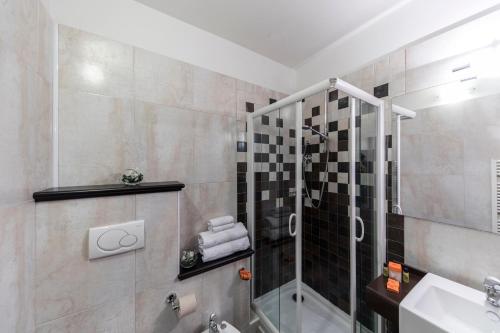a bathroom with a shower and a sink at Hotel Donatello Imola in Imola