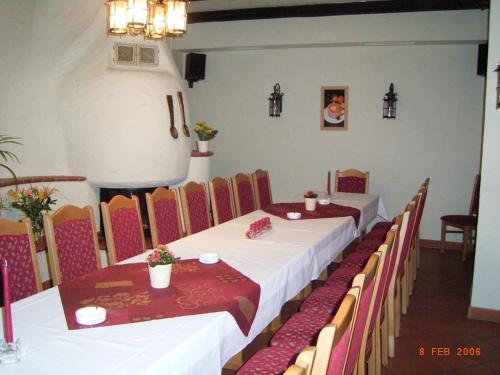 a dining room with two tables and chairs at Pension & Gasthaus Kahren in Kahren