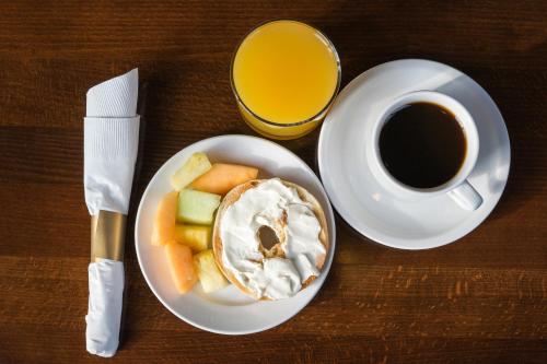 a plate of food with fruit and a cup of coffee at The Wildwood Hotel in Wildwood
