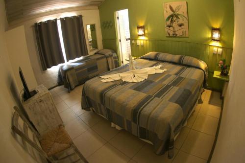 Cama o camas de una habitación en Pousada Tatuapara