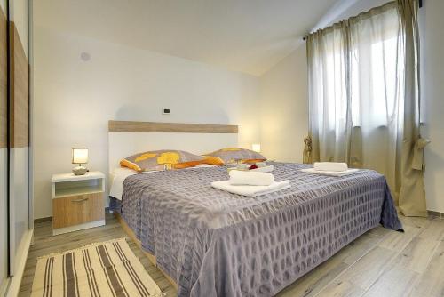 a bedroom with a large bed with two dishes on it at Villa Rudy in Štinjan