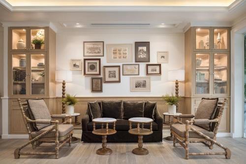 a living room with a couch and two chairs and a table at Casa Vimaya Riverside in Bangkok