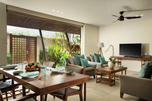 a living room with a table and chairs at The Tamarind Resort - Nusa Lembongan in Nusa Lembongan
