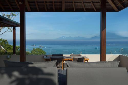 a view of the ocean from a restaurant with tables and chairs at The Tamarind Resort - Nusa Lembongan in Nusa Lembongan