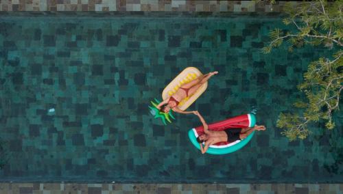 a man in a banana costume on a raft in the water at The Tamarind Resort - Nusa Lembongan in Nusa Lembongan