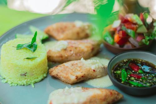 a blue plate of food with rice and a salad at Aathma Colombo House in Colombo