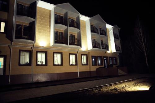 a building at night with lights on it at Aska Hotel in Naryn