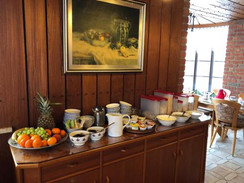 a table with bowls of fruit on top of it at Landhaus Jägerhof in Börnsdorf