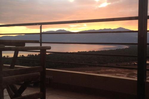 a view of a lake from a balcony at sunset at Harmony Maisonette in Schinias