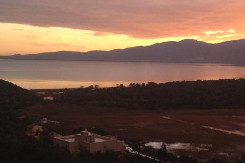 a sunset over a large body of water at Harmony Maisonette in Schinias