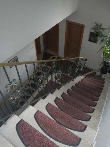 a stairway with a staircase with red and white carpet at Gästehaus Brigitte in Garmisch-Partenkirchen