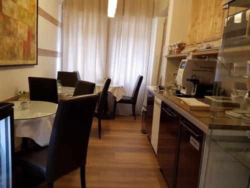 a kitchen with a table and chairs and a counter at 3Jolie in Verona