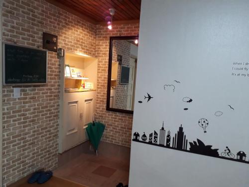 a hallway with a wall with cities and birds on it at Casa Cielo in Seoul