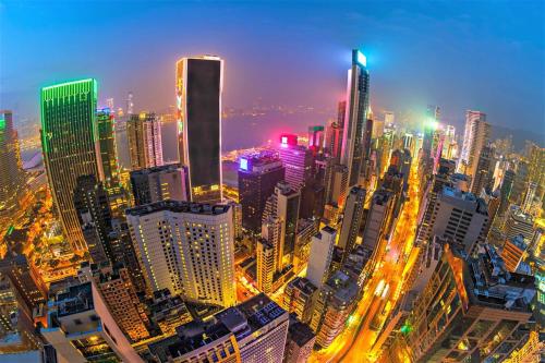 una gran ciudad por la noche con edificios iluminados en Ashoka Hostel, en Hong Kong