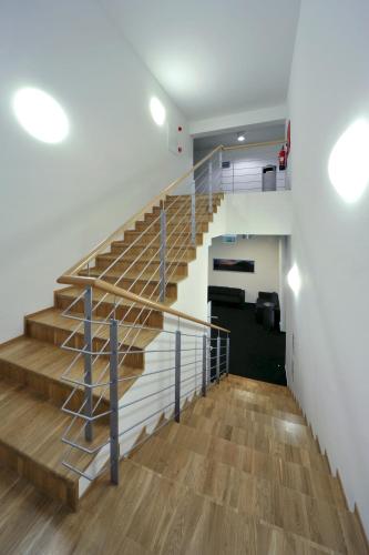 a staircase in a house with wooden floors and white walls at Penzion Andula Friesovy boudy in Strážné