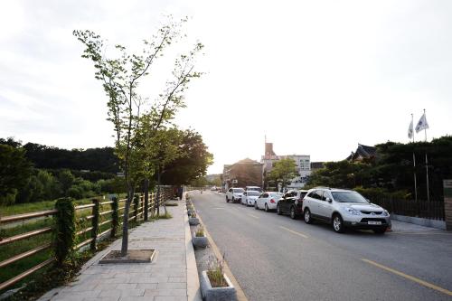 a row of cars parked on the side of a street at Starlight Rest Area in Jeonju