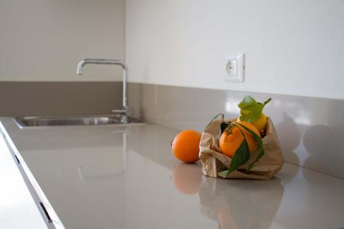 a bag of oranges sitting on a counter in a kitchen at Ingrappa Sporthouse in Borso del Grappa