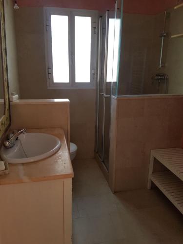 a bathroom with a sink and a shower and a toilet at Casa Las Toro Playa in Chilches