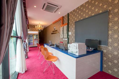 an office with a counter with chairs and a screen at Hamilton Hotel Kajang in Kajang