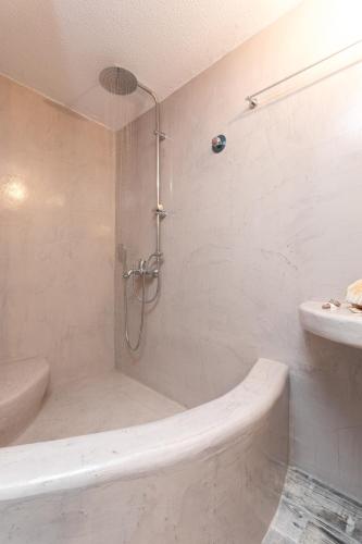 a bathroom with a shower with a tub and a sink at Relax Studios in Naxos Chora