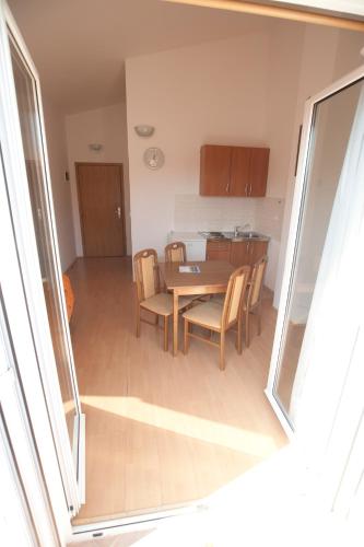 a kitchen and dining room with a table and chairs at Apartments Maric with parking in Umag