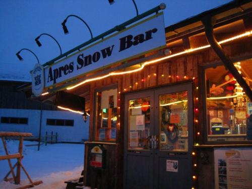 a sign for a snow bar with lights on it at Gasthof Meindl in Arrach