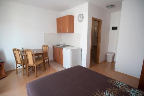 a room with a table and a kitchen with a table and chairs at Apartments Maric with parking in Umag