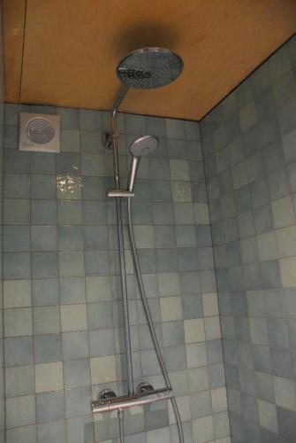a shower with a shower head in a bathroom at Gite des Bois de Spa in Spa