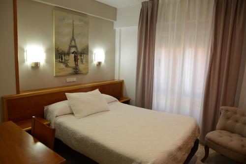 Postel nebo postele na pokoji v ubytování Hotel Escudero