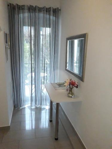 a white table with a mirror and a window at Rooms Miletic near the Palace in Split