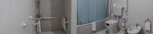 a bathroom with a mirror and a toilet and a sink at Hotel Rota Malhoa in Figueiró dos Vinhos