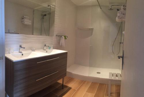 a bathroom with a sink and a shower at Le Galion Hotel et Restaurant Canet Plage - Logis in Canet-en-Roussillon