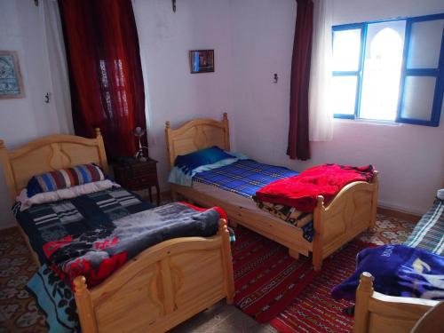 Cama o camas de una habitación en Dar Bleu Pearl