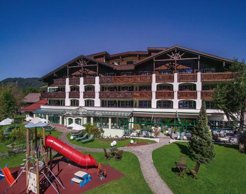 a large building with a slide and a playground at Hotel Sägerhof in Tannheim