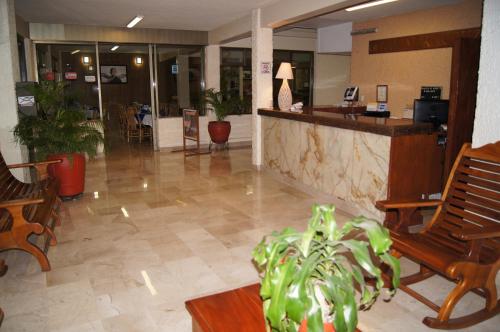 a lobby with two chairs and a reception desk at Hotel Veracruz in Oaxaca City