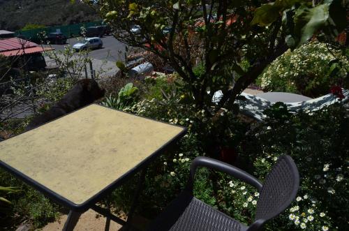 a table and a chair sitting next to a table and a table and a table at Rural Gomera in Arure