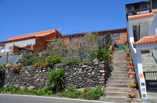 a stone retaining wall and stairs next to a building at Rural Gomera in Arure