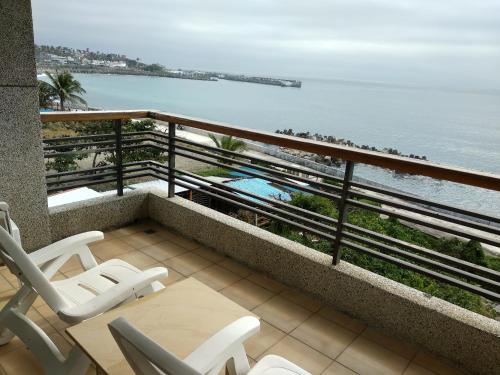 a balcony with chairs and a view of the ocean at Sea Bay in Taitung City