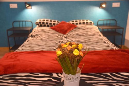 a bedroom with a large bed with red pillows and flowers at 66 Szyszek in Susiec