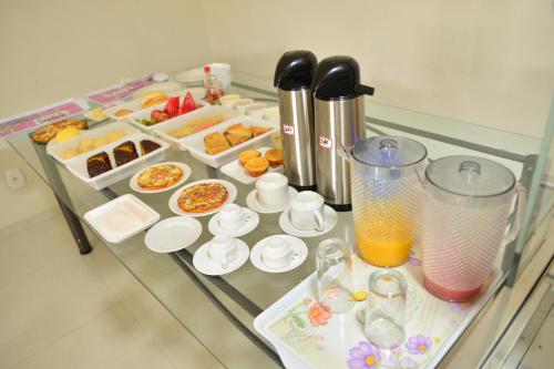 a table with many different types of food on it at Hijo Buriti Hotel in Mauriti