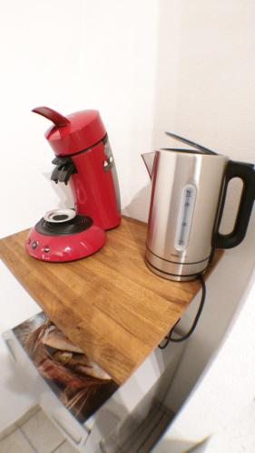 a red and silver appliance sitting on a cutting board at Le Contemporain in Montbéliard